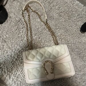 White purse with gold chain